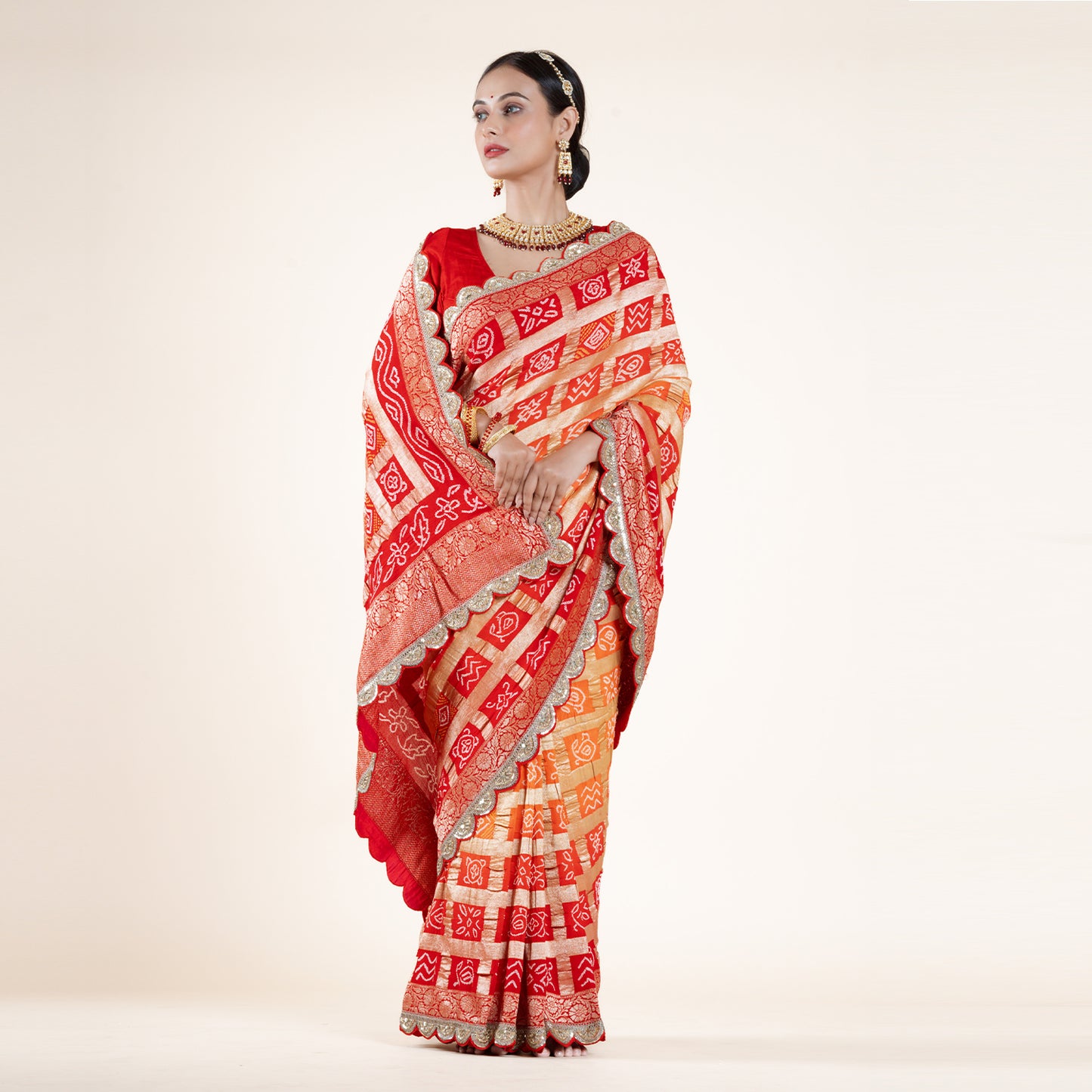 Red-Orange Bandhani Saree with Gold Zari Accents